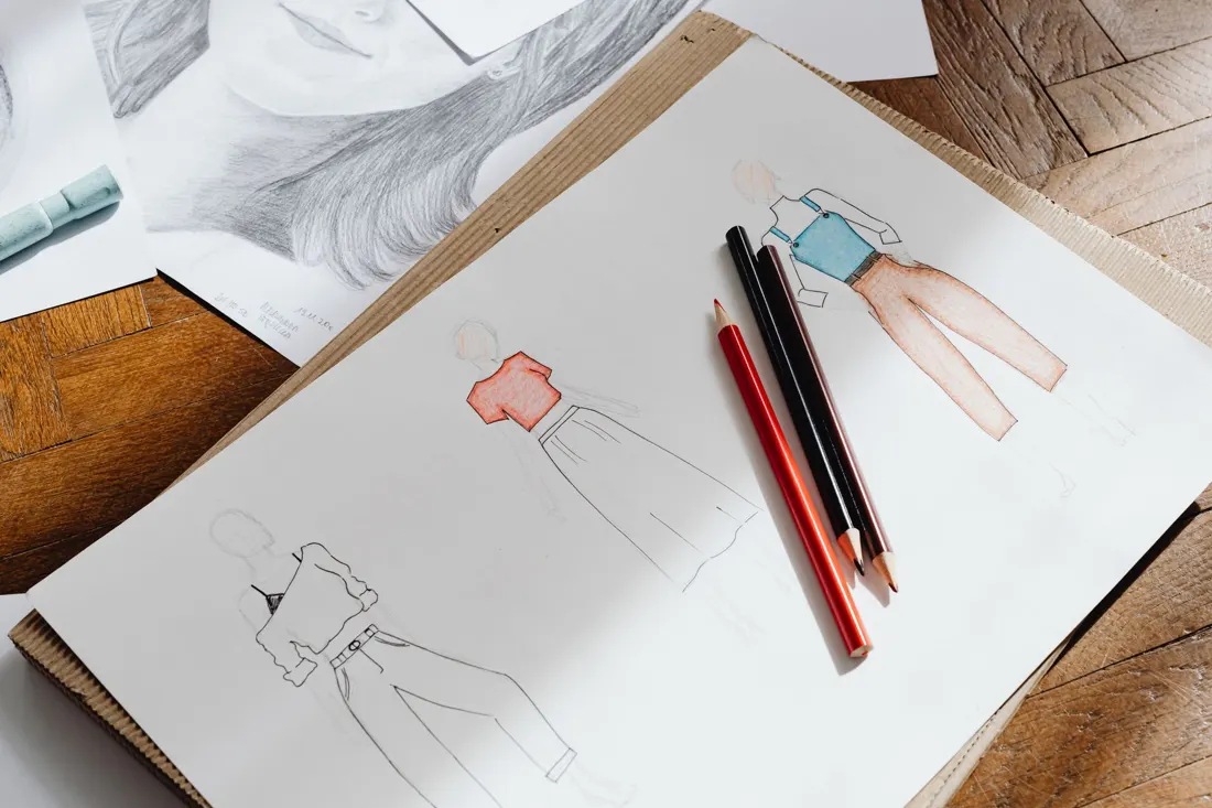 Fashion sketches on paper with coloured pencils